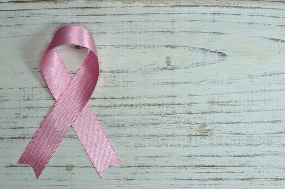 A pink cancer ribbon symbolizing breast cancer awareness and support