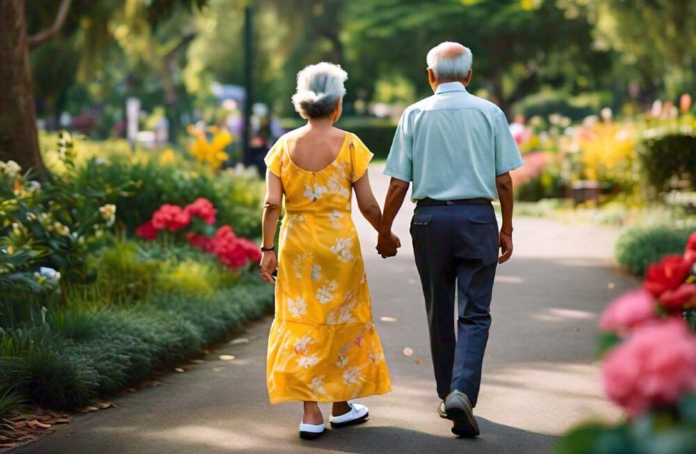 An elderly couple walking in a park, representing improved mobility and joint health.